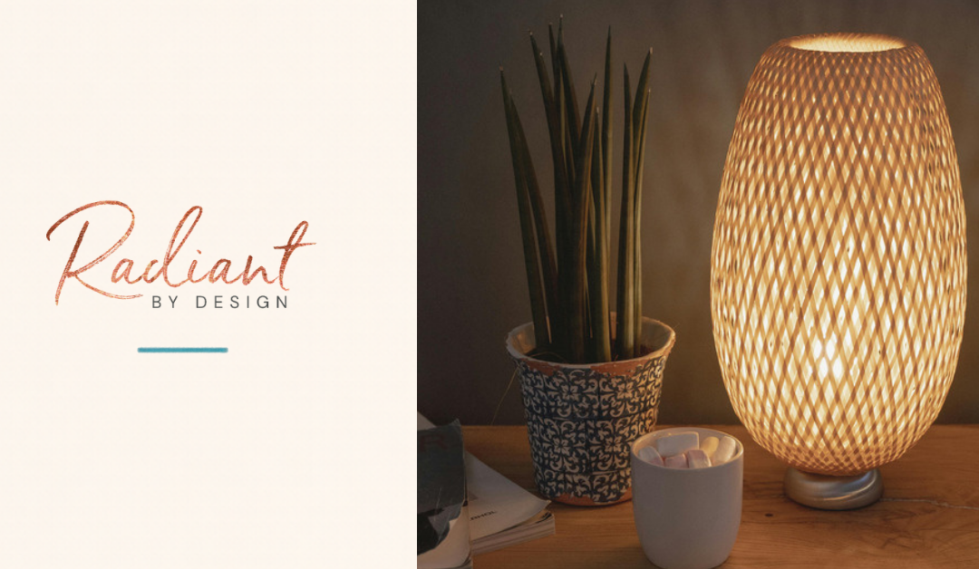 A woven bamboo lamp glowing warmly on a wooden nightstand beside a patterned plant pot and a mug of marshmallows.