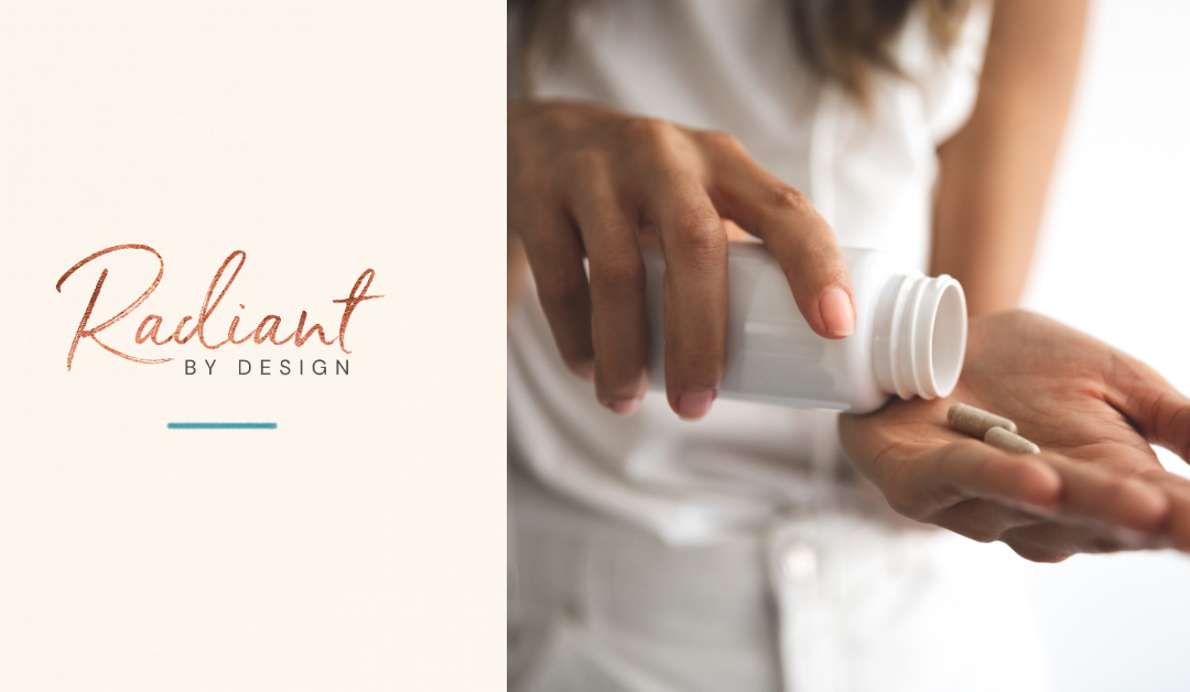 A woman in a white shirt tips two capsules from a white bottle into her open hand.