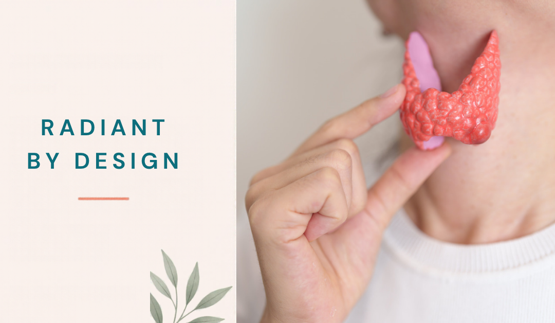A woman's hand holds a pink and coral anatomical thyroid model against her neck.